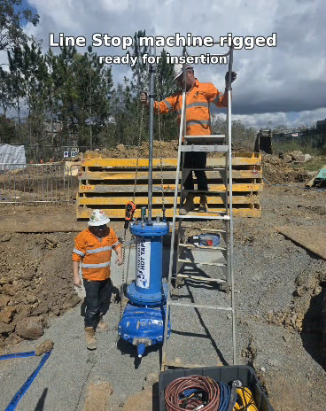 Line stopping machine rigged on a ladder platform, ready for insertion into the live main