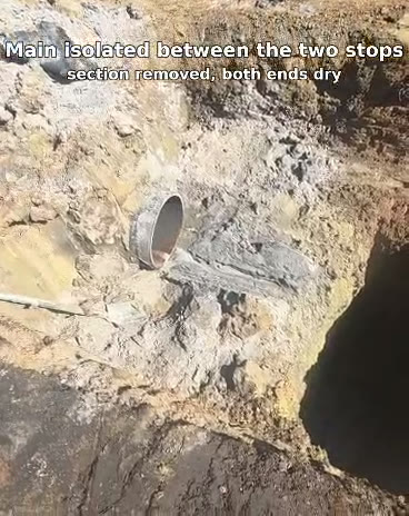 Water main isolated dry between two line stops, with the old section cut out